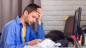 man holding his head because he is tired