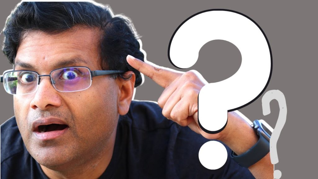 Man pointing to his head with a finger next to a question mark