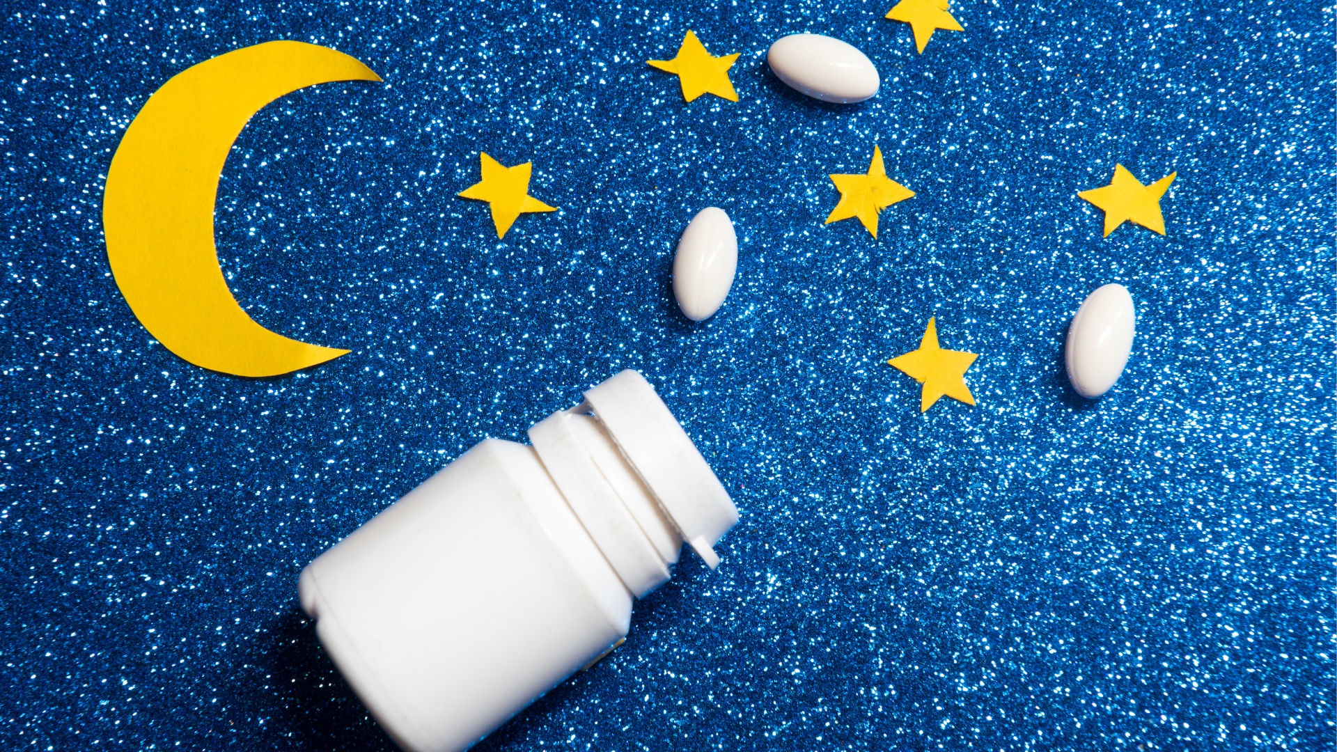pill holder on side with pills against the background of night sky
