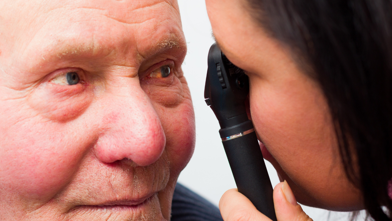 doctor examining an eye with ophthalmoscope