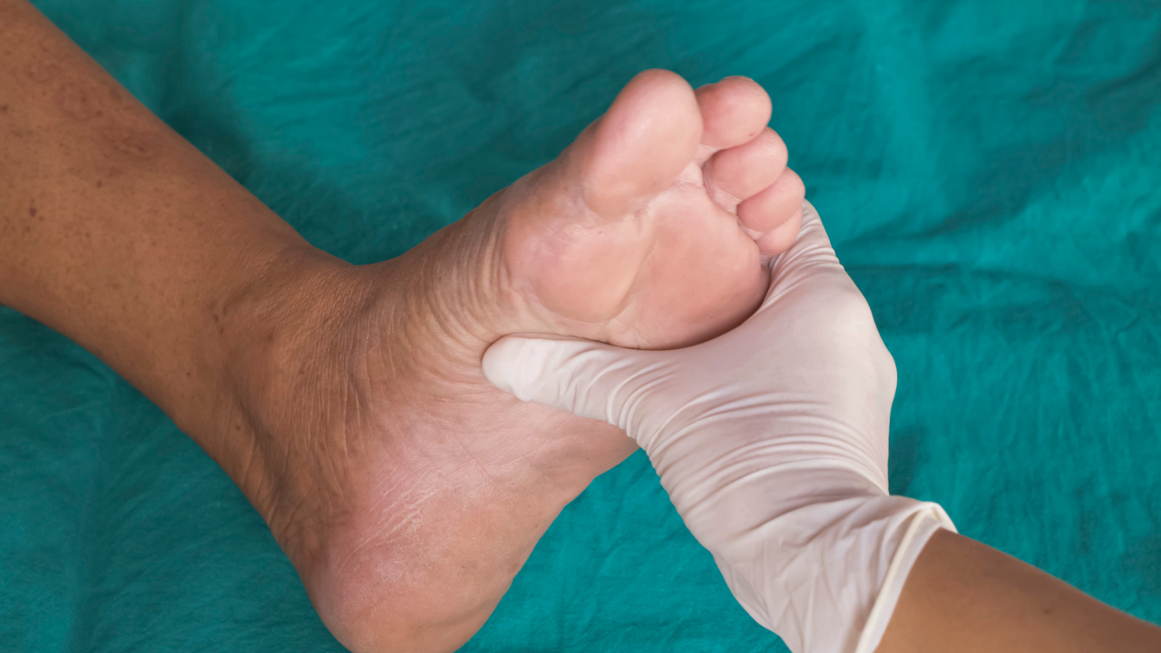 man holding a foot for diabetes examination
