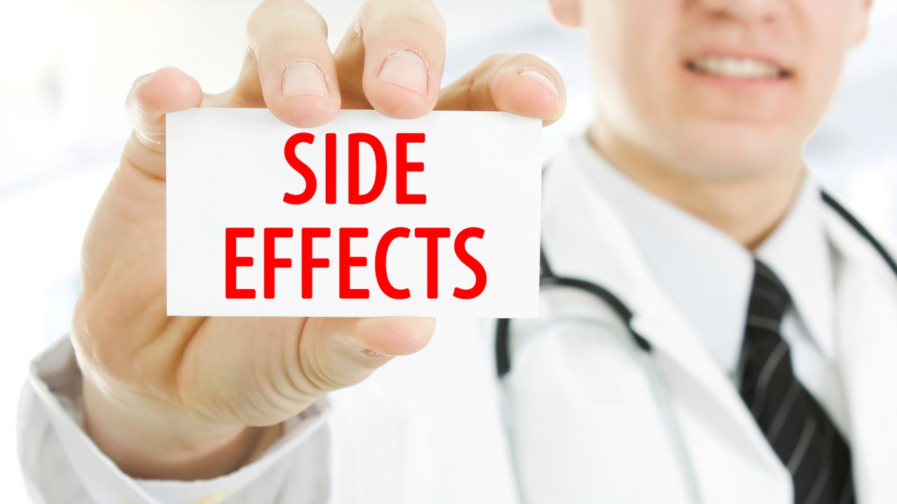 Man holding up a card with the following words: side-effects