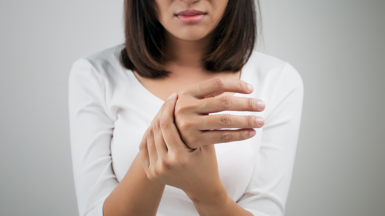 Woman holding her right wrist because of pain