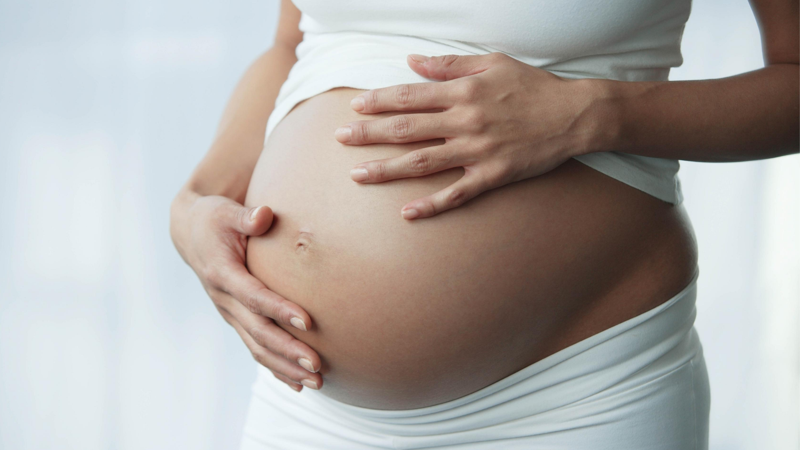 Pregnant woman touching her belly