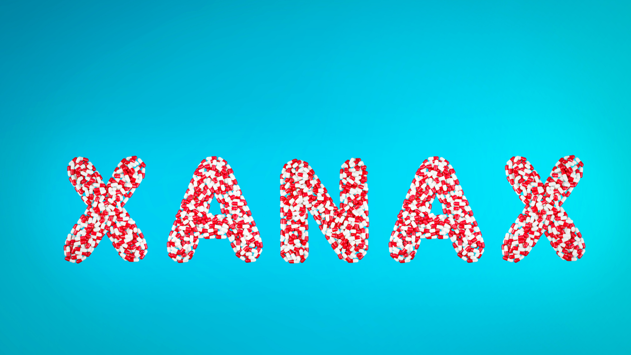 Blue background with word Xanax in red & white