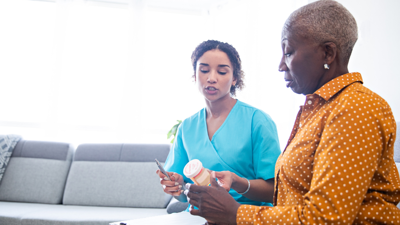 African american Woman look at medication vials with a provider