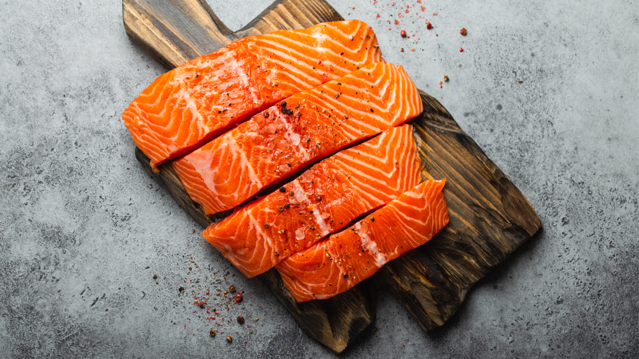 pink cut salmon on a wooden fish plate