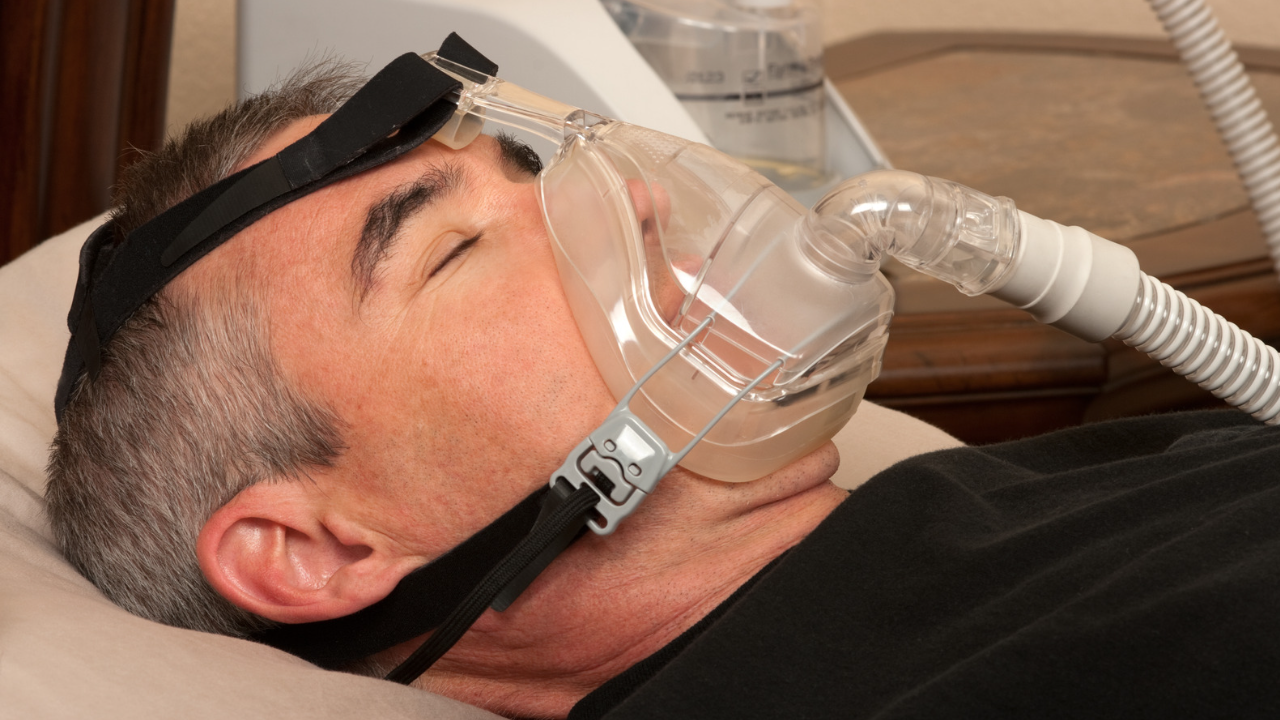 man lying with CPAP mask