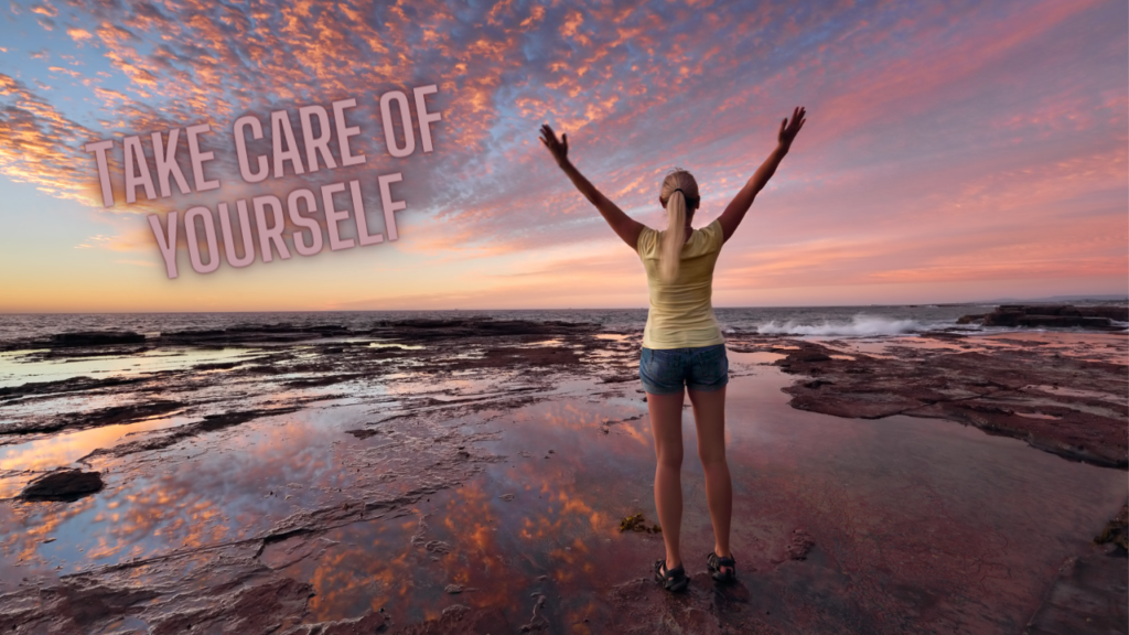 woman standing at beach with outstretched arms