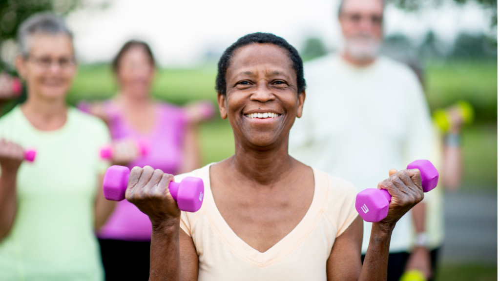 african american woman smiling holding weights
