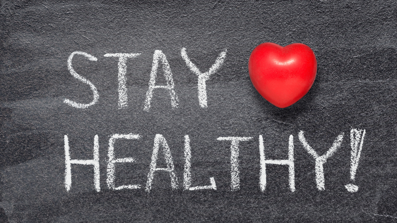 Blackboard with red heart with words stay healthy